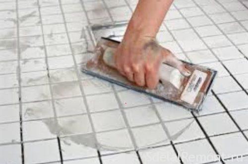 grout the tiles with their hands